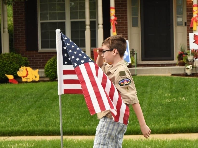 Grant Buchner, 12, salutes an American flag on Memorial Day 2020.