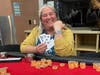 Sarah Nakao shows her winning hand and winner's bracelet.