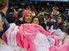 Kara Walsh, a 44 y.o. breast cancer survivor, celebrates being cancer-free by unfurling a pink ribbon at Soldier Field. 11 other survivors participated.