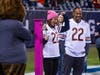 Kara Walsh, Dr. Sandeep Chunduri, and Staley da Bear celebrate the end of her breast cancer treatment at halftime.