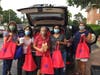Assistance League volunteers delivering bags of toiletries to HCS Community Services food pantry