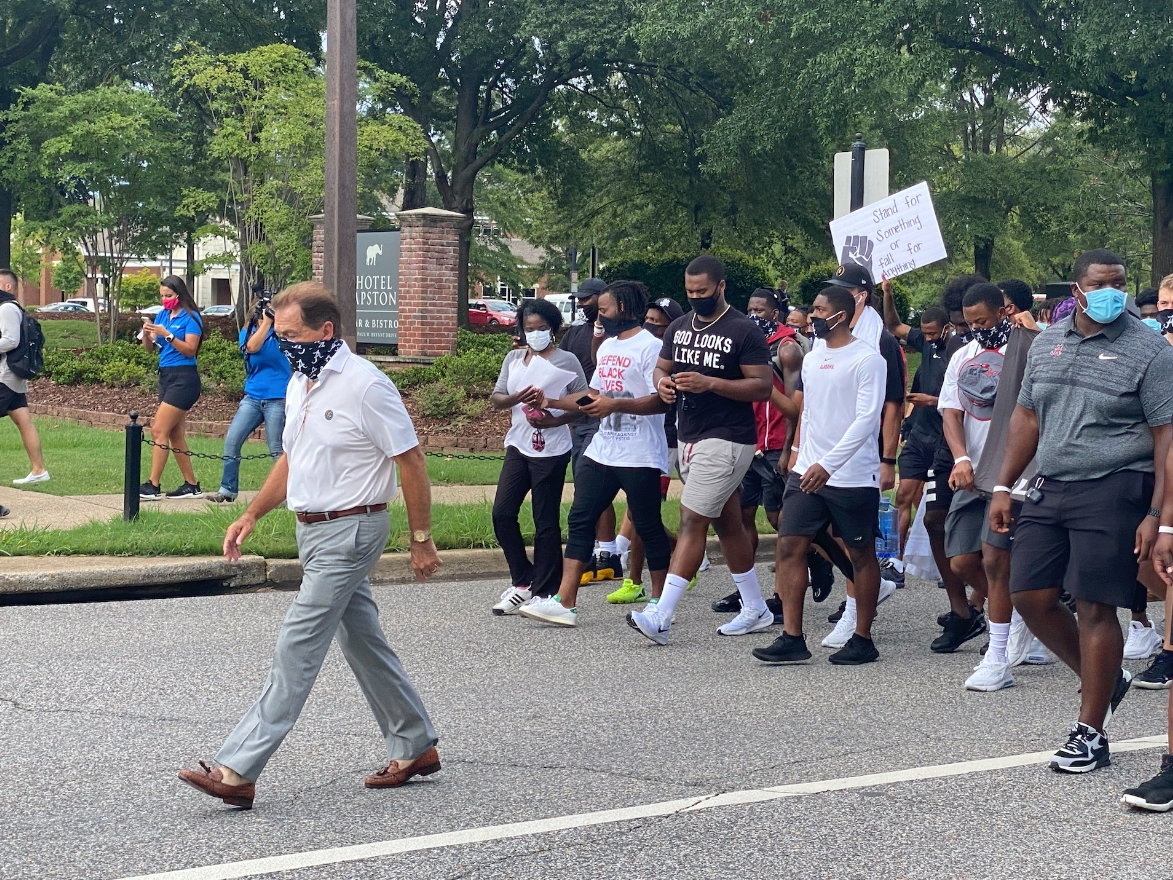 Alabama football coach Nick Saban leads a march to Foster Auditorium on Monday