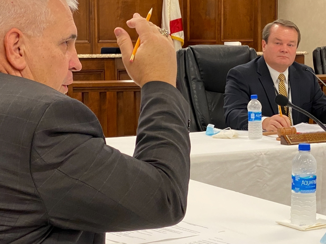 District 1 Commissioner Stan Acker (left) makes a point as Commission President Rob Robertson looks on.