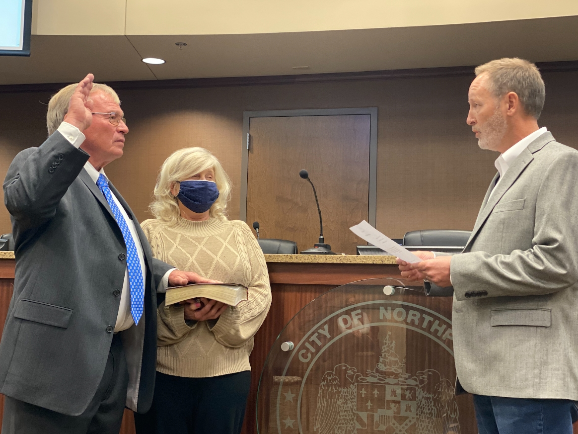 Northport Mayor Bobby Herndon was sworn in Monday by former City Administrator Scott Collins as his wife Kay Herndon holds the Bible.