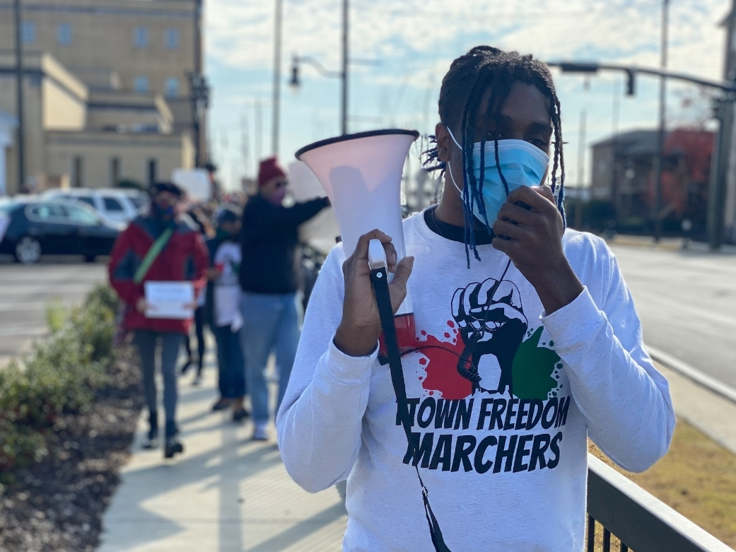 Activist and T-Town Freedom Marcher Lux Murray leads a chant in front of the Tuscaloosa County Sheriff's Office on Saturday as protestors demanded the release of COVID-19 jail data