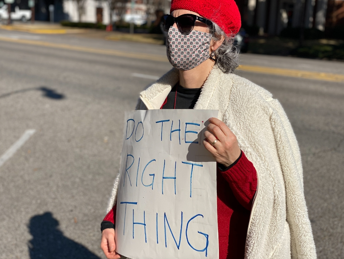 A demonstrator holds a sign during a November protest at the Tuscaloosa County Courthouse following a lawsuit filed against Sheriff Ron Abernathy, which claimed the sheriff failed to respond to requests for COVID-19 jail data. 