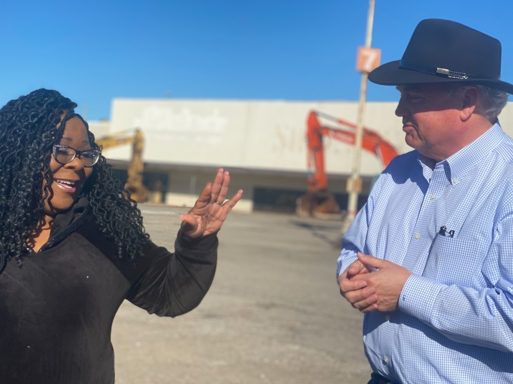 District 7 Councilor Sonya McKinstry, left, and businessman Stan Pate share a laugh as the demolition of the McFarland Mall began Tuesday morning. 