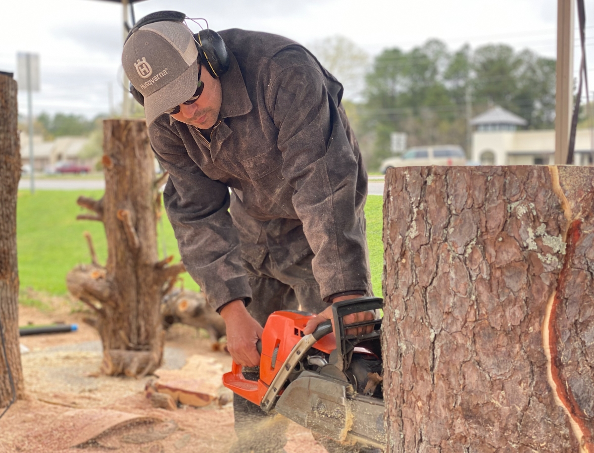 Chad Gainey shows off his chainsaw skills Friday at Northport Power Equipment. 