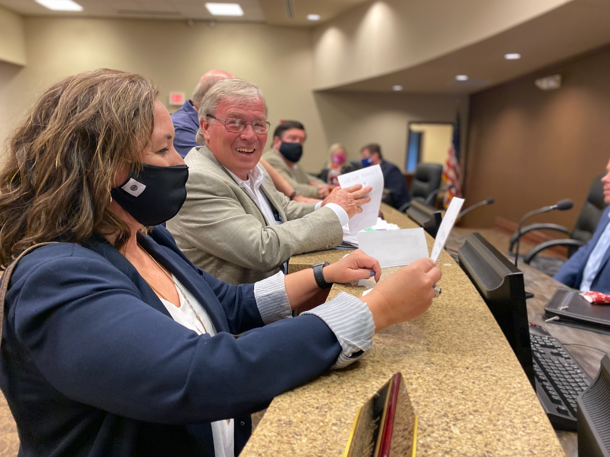 Incoming Northport City Administrator Glenda Webb (left) looks over thank you cards delivered to the city from local school children as Mayor Bobby Herndon looks on. 