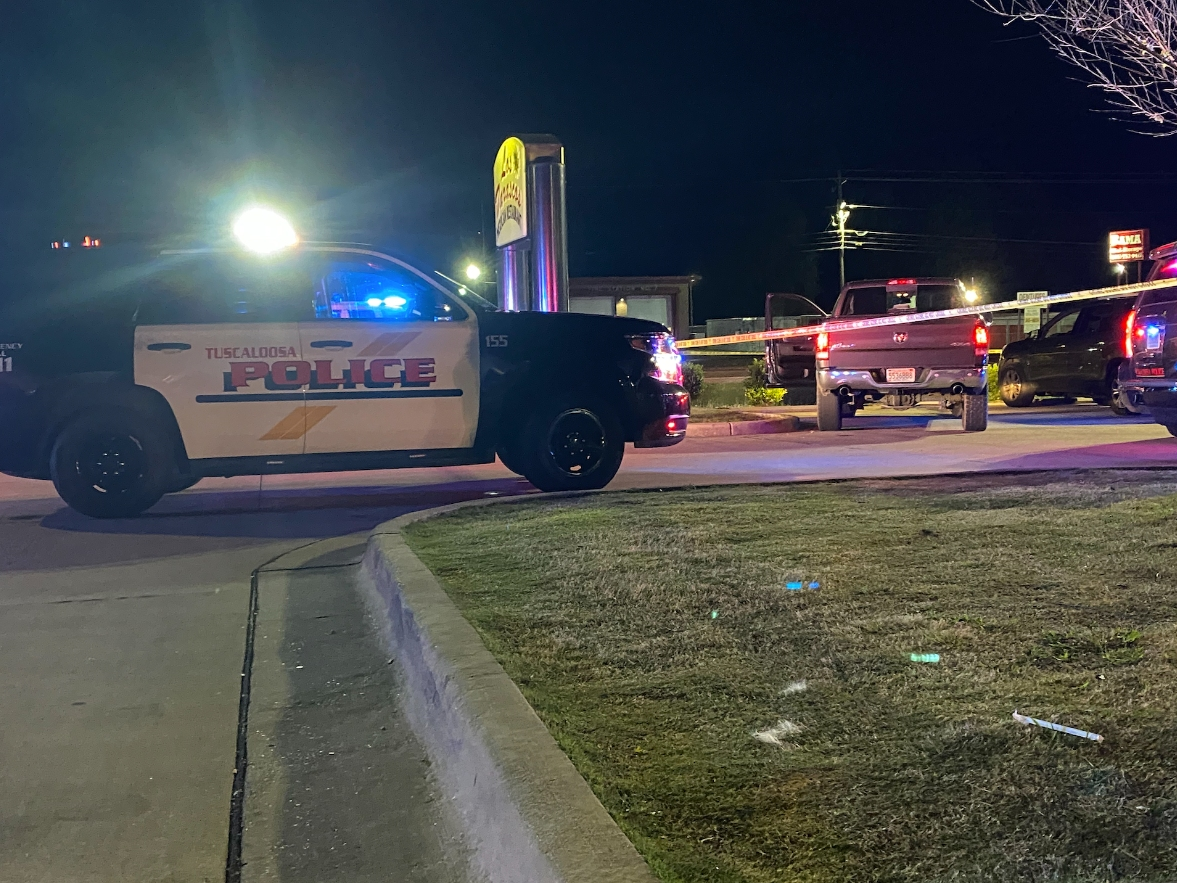 The truck on the right was a point of focus for officers and left behind crime scene tape with the driver's side door open.