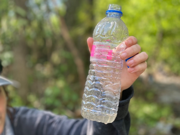 A water sample is held up following an oil spill near a Northport elementary school and two neighborhoods.
