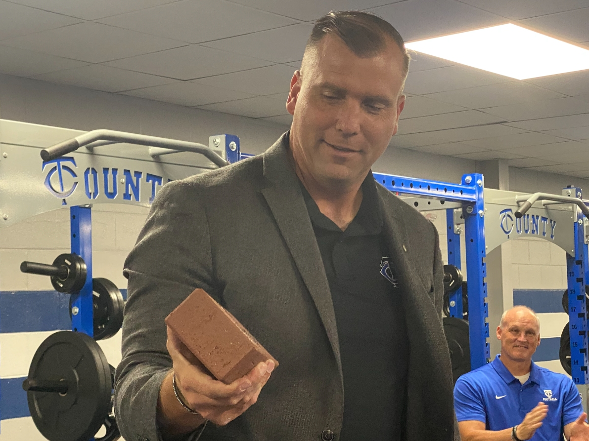 TCHS football coach Adam Winegarden holds one of the new bricks that will be placed in the Legacy Walk from the field house to the football field. 