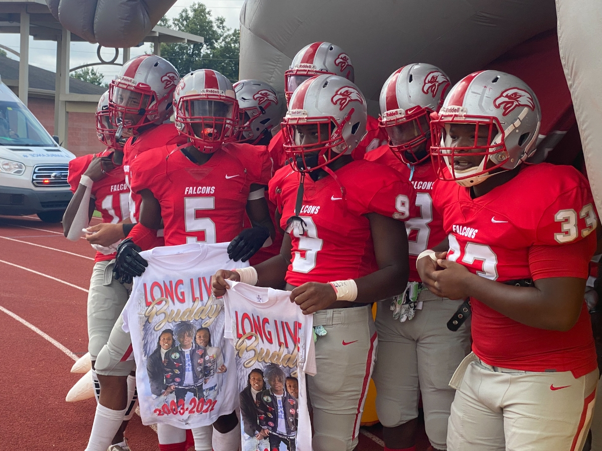 The Central Falcons prepare to take the field before their game against Northridge, which was initially postponed and then rescheduled due to heightened tensions in the community. 