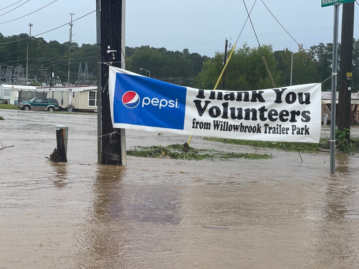 The sign from the volunteer effort from flooding on June 19 was still up as flood water engulfed Willowbrook Trailer Park Saturday. 