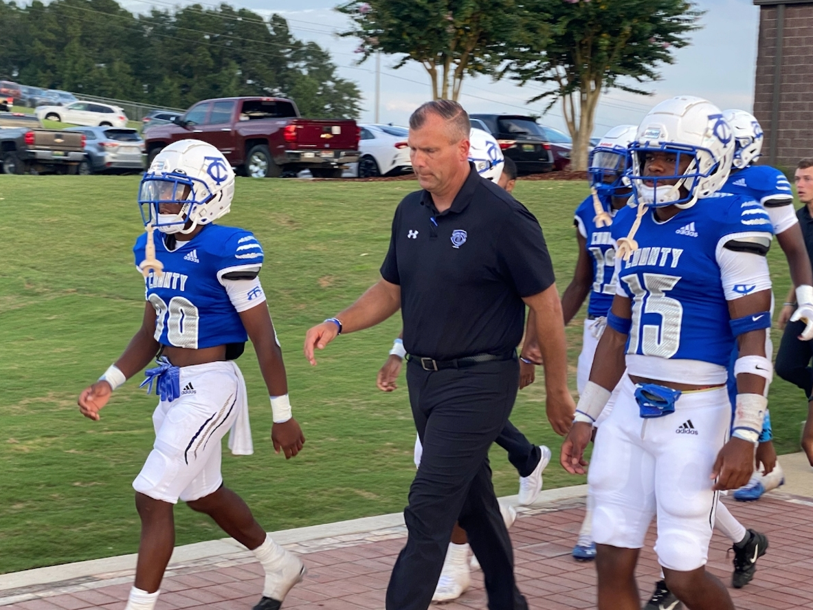 TCHS football coach Adam Winegarden leads the Wildcats to the field for his first game as head coach. 
