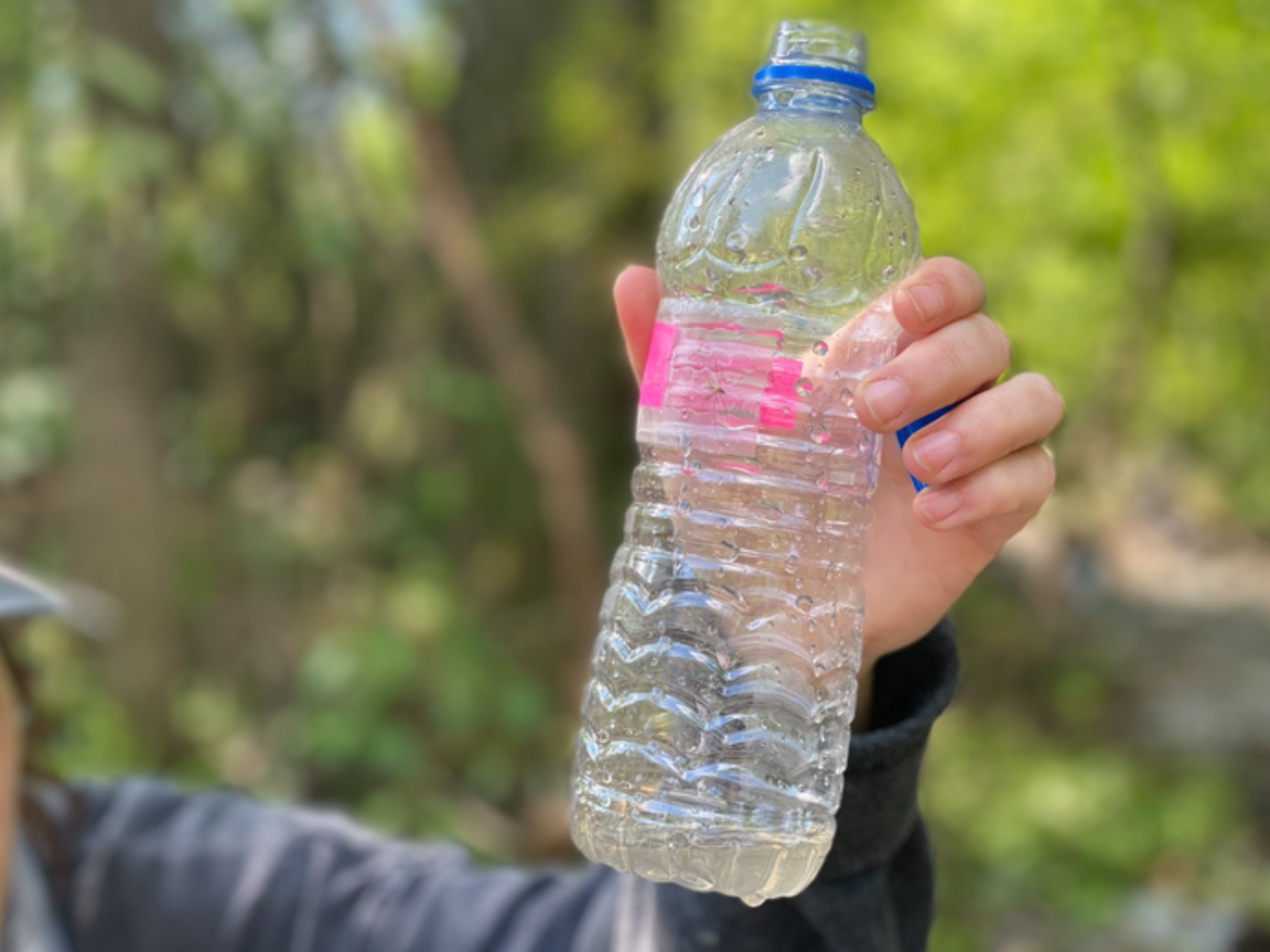 Palmetto Street resident Sam Key holds up a water sample from the spill site in April. 