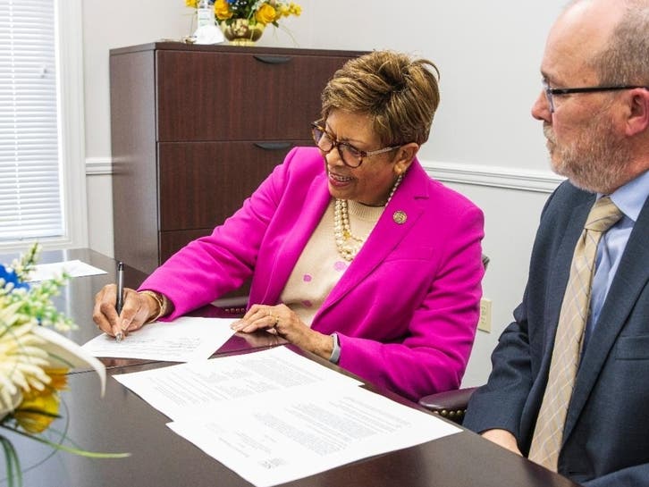 Cynthia Warrick, president of Stillman College, signs a MOU with Southern Illinois University’s School of Law as Mark McCormick, Stillman College provost, looks on. 