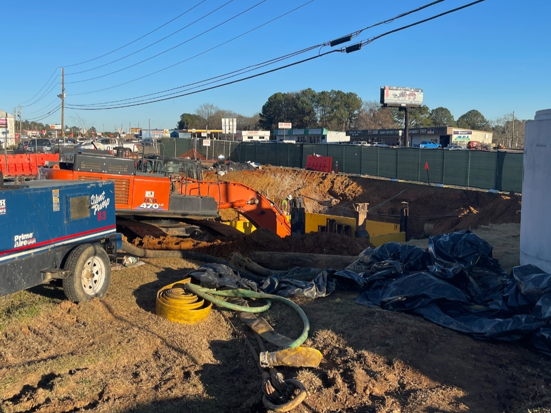 A distant view of the sinkhole site on the east end of the city hall property