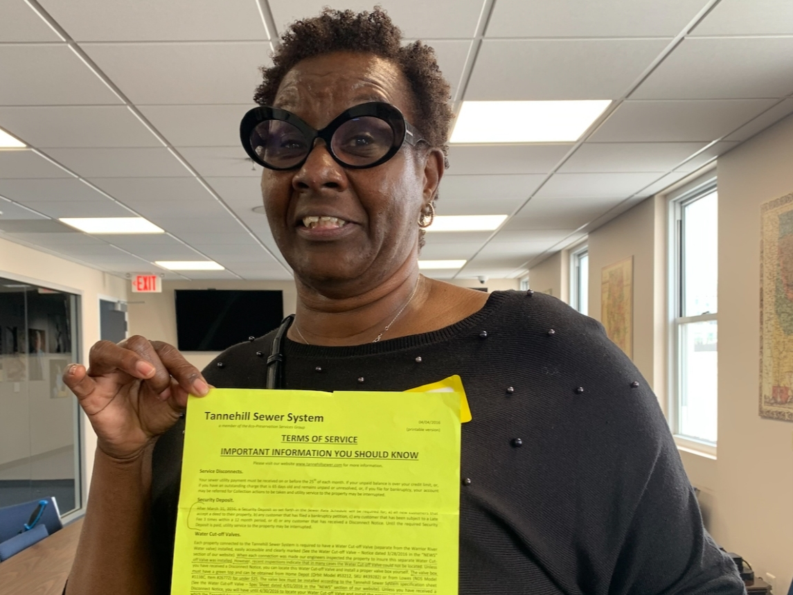 Lake View resident Sharon Scarborough shows a notice she received from Tannehill Sewer regarding required cut-off valves for homeowners. 