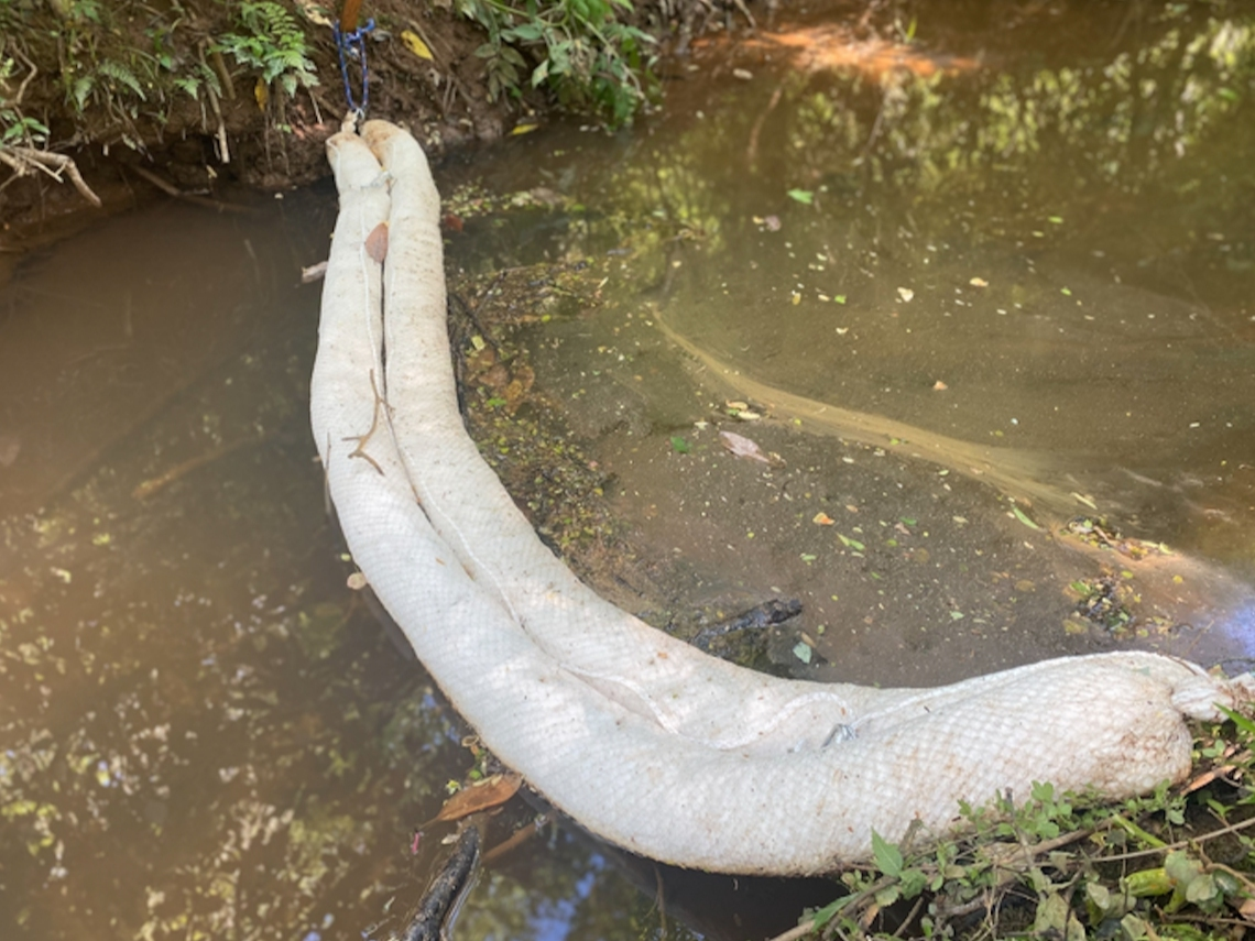 One of the booms placed in a stream near the site of the oil spill