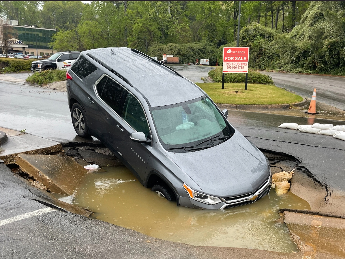 The Chevrolet Traverse in the sinkhole on Afflink Place.