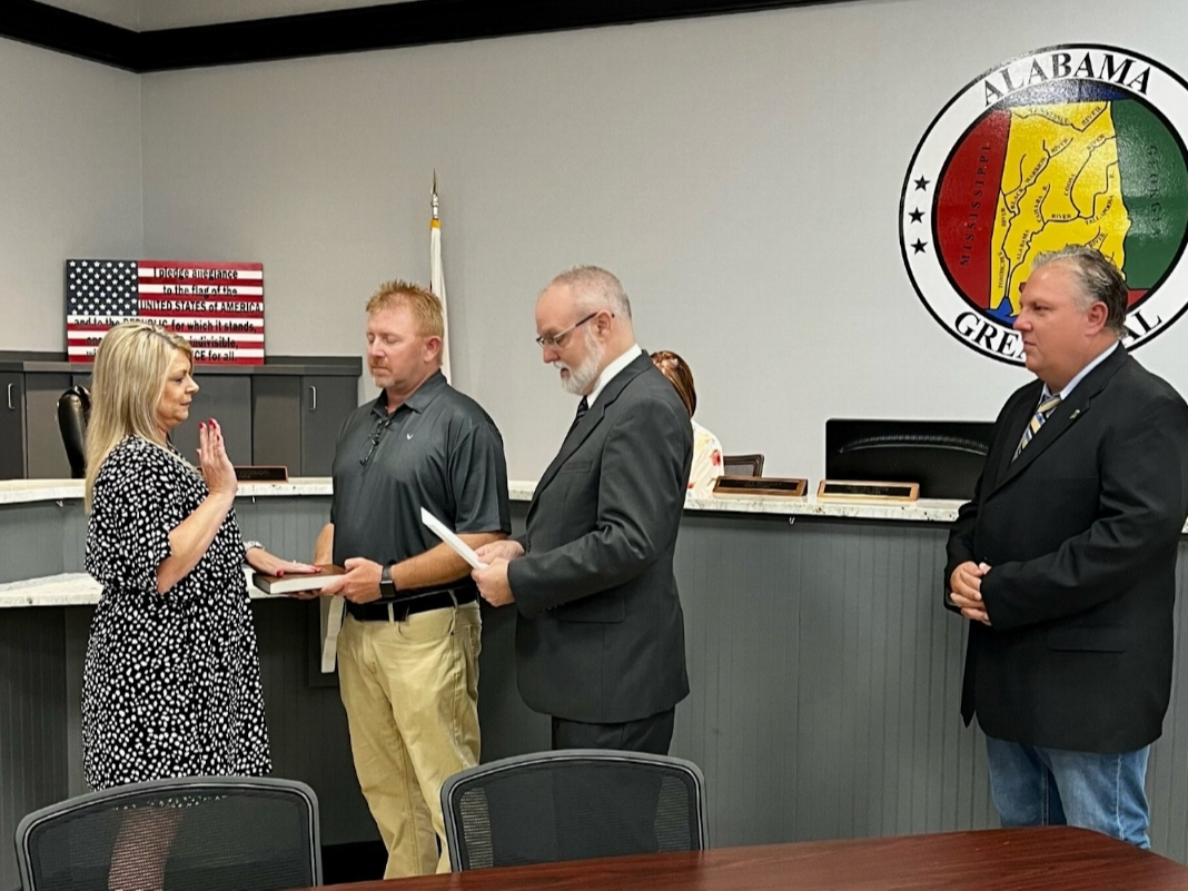 Kellie Parks is sworn in while her husband Bryan Parks holds the Bible. She was sworn in by Judge Edward Vines, as Mayor Jeff Dodson looked on. 