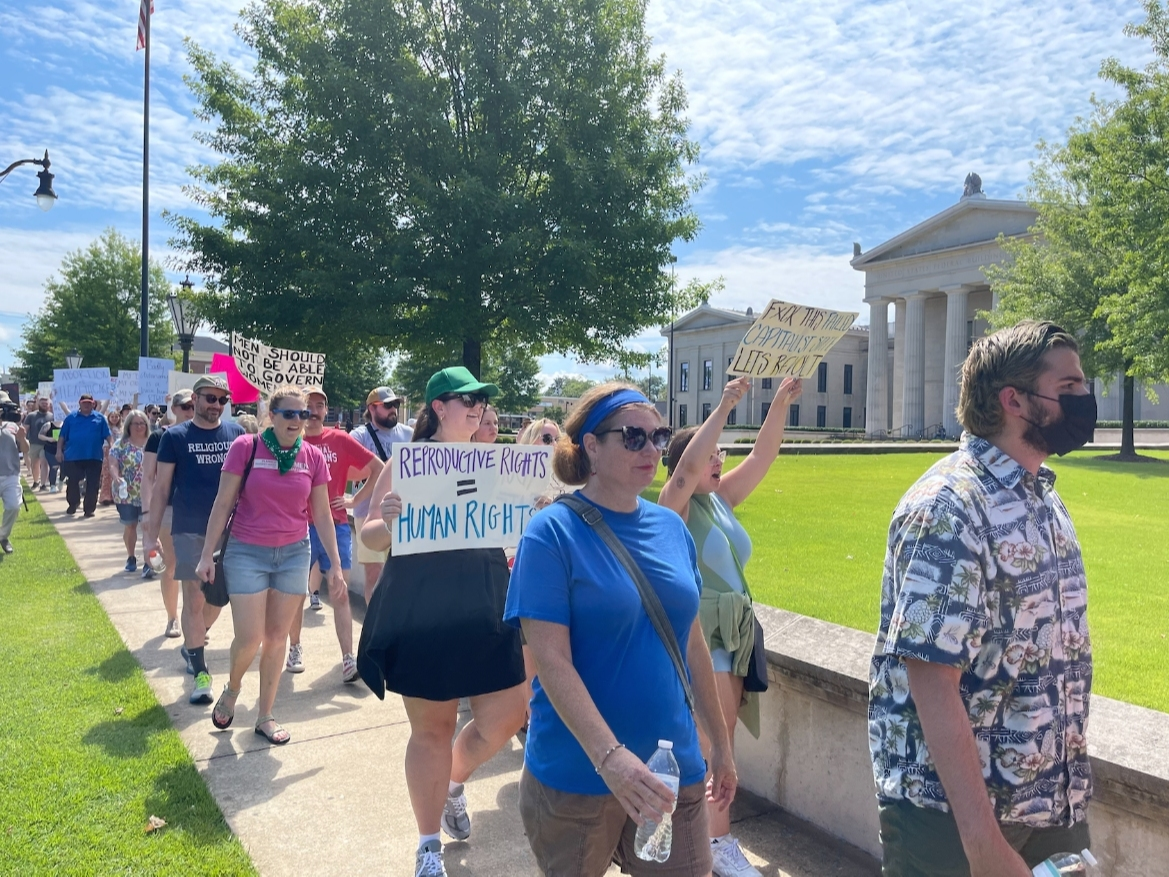 Protestors march around the federal courthouse in downtown Tuscaloosa Monday