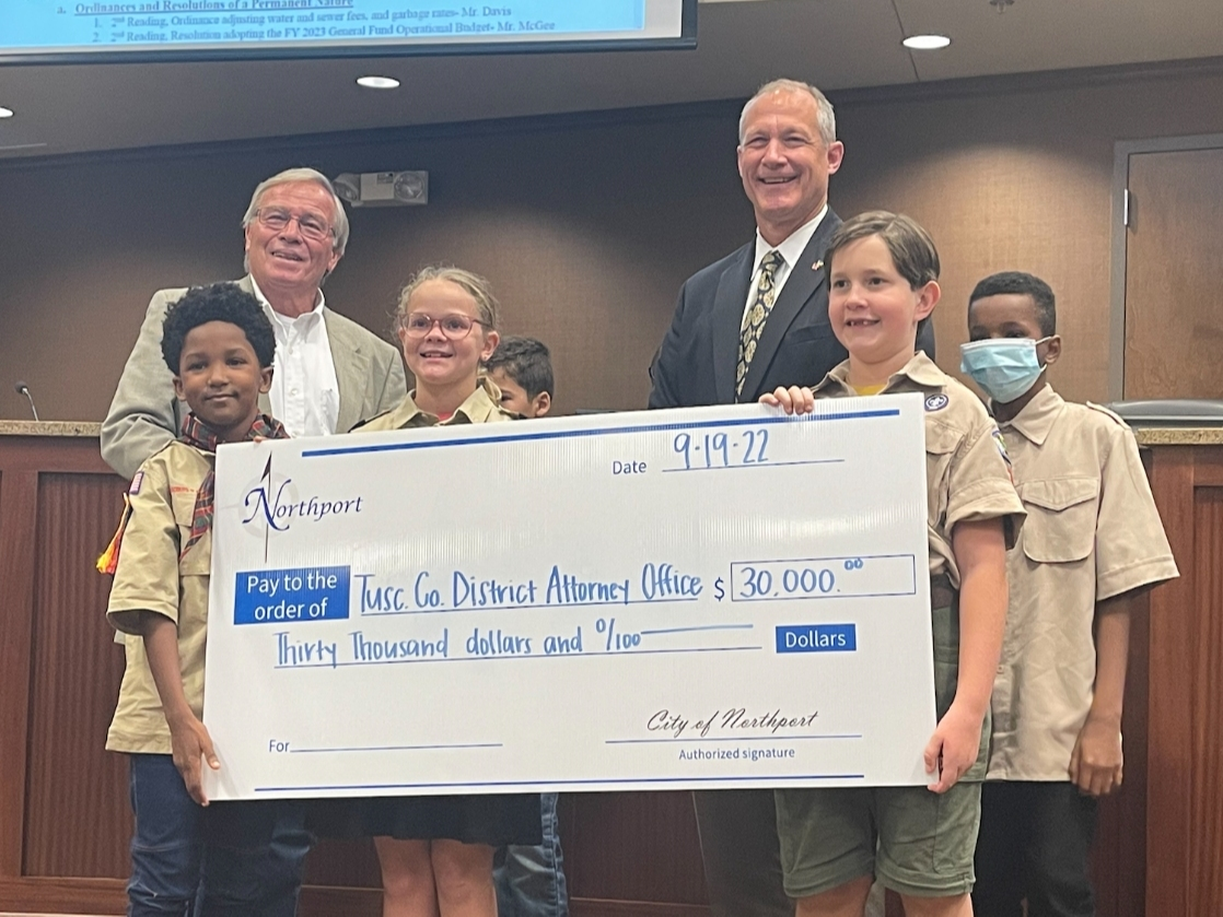 Northport Mayor Bobby Herndon (left) and District Attorney Hays Webb pose for a photo with a group of local scouts as part of the check presentation. 