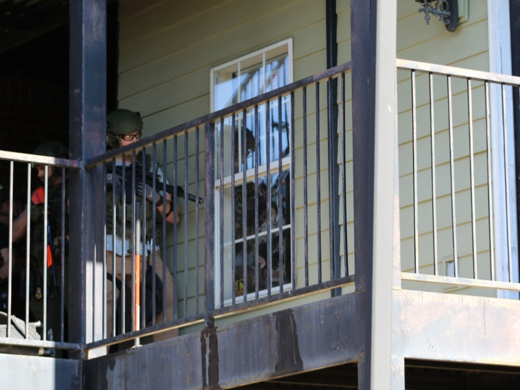 Members of the Special Response Team at the door of the apartment on Sunday