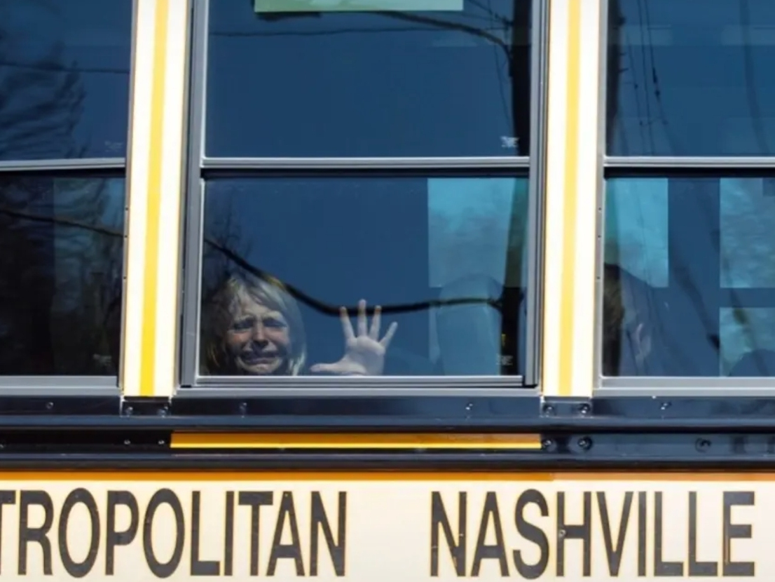 A child weeps while on the bus leaving The Covenant School following a mass shooting at the school in Nashville, Tenn., Monday, March 27, 2023.