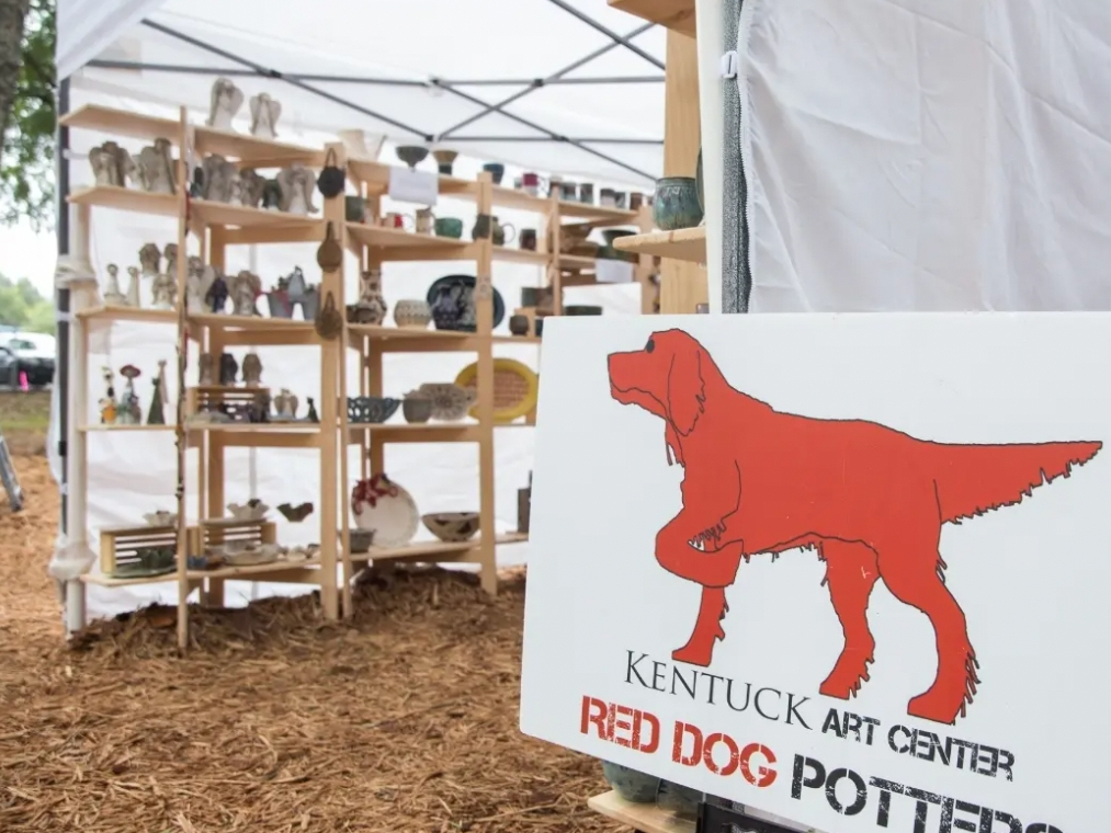 A sign marks the tent for Red Dog Potters at the 2019 Kentuck Festival of the Arts