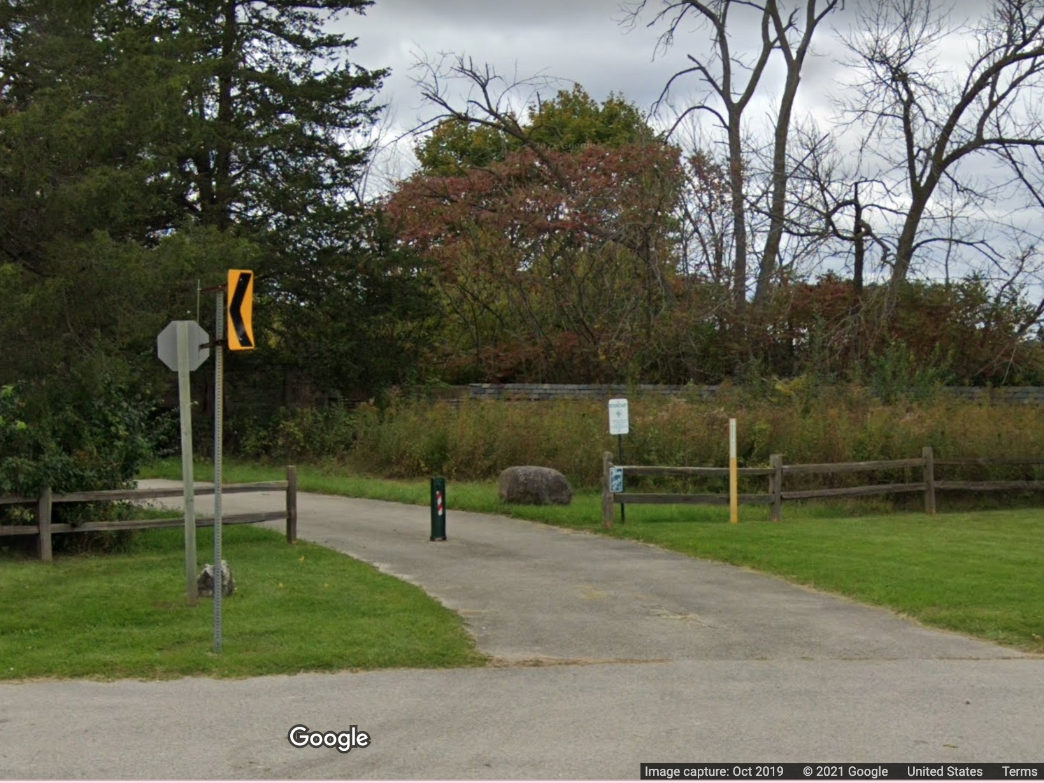 The Gate stands surrounded by trees and off a trail along North River Road. What happened behind The Gate several years ago, including tales of a mass killing, are up for debate.