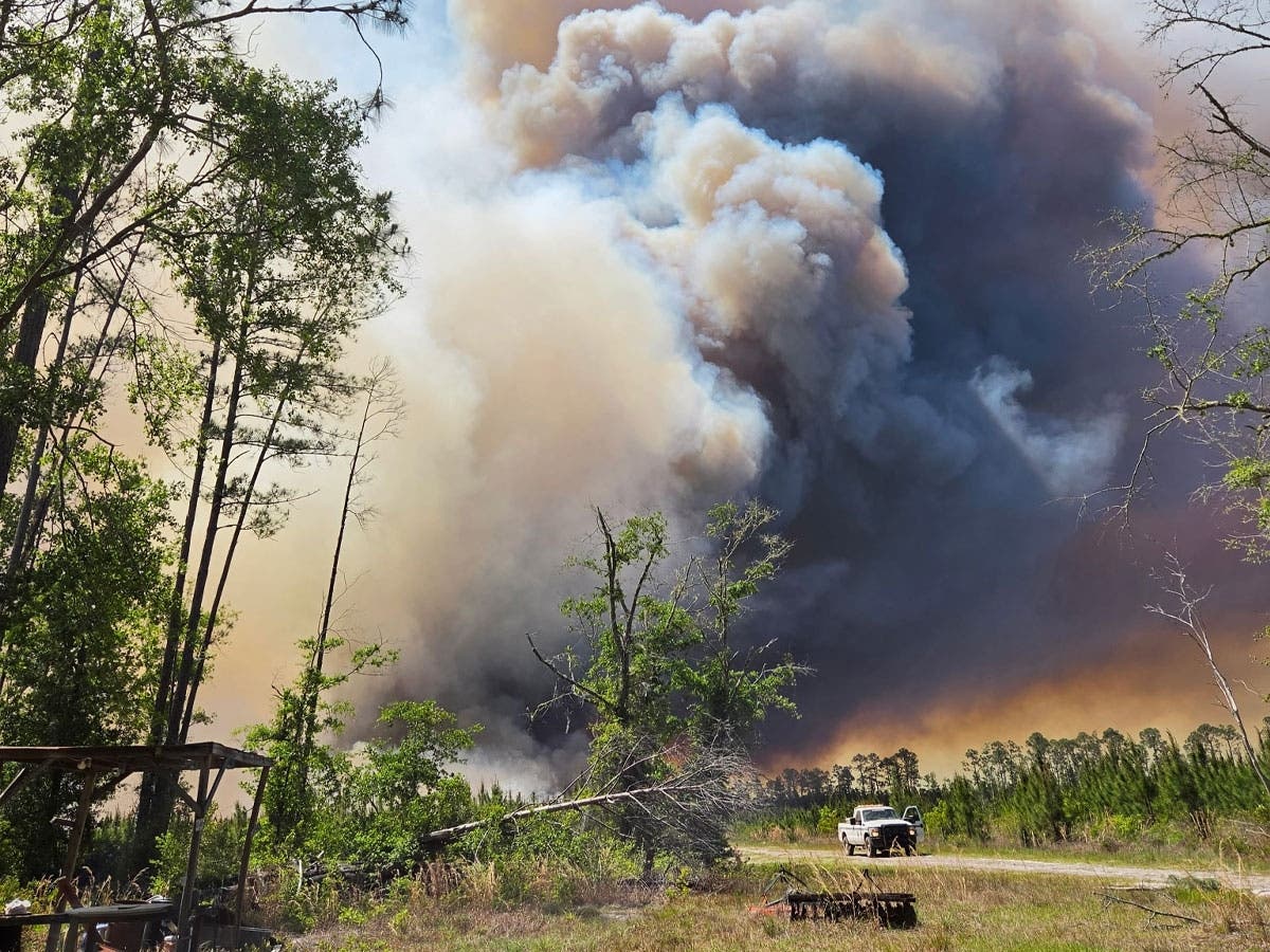 Smoke clouds loom over the Pineland Road fire this week in Clinch County.