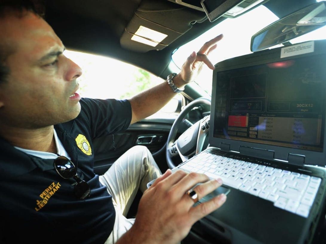 Brian A. Pounds' August 15, 2013 photograph of Fairfield Police Lt. James Perez demonstrating Fairfield PD's cruiser-mounted license plate reader system.