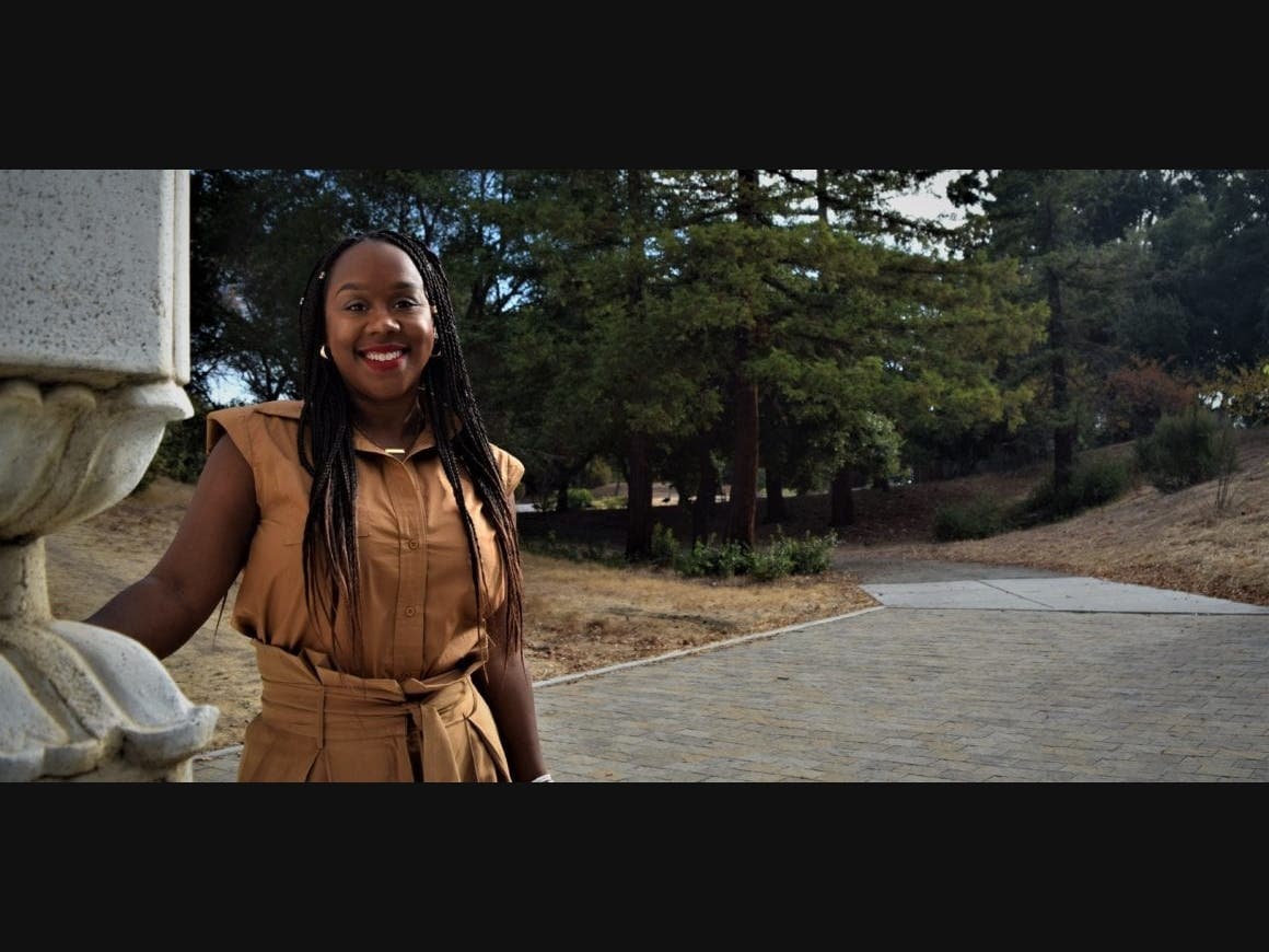 Thomishia Booker, author and CEO of Hey Carter! Books, reminisces at Overfelt Gardens in San Jose, in the neighborhood where she was born and raised.
