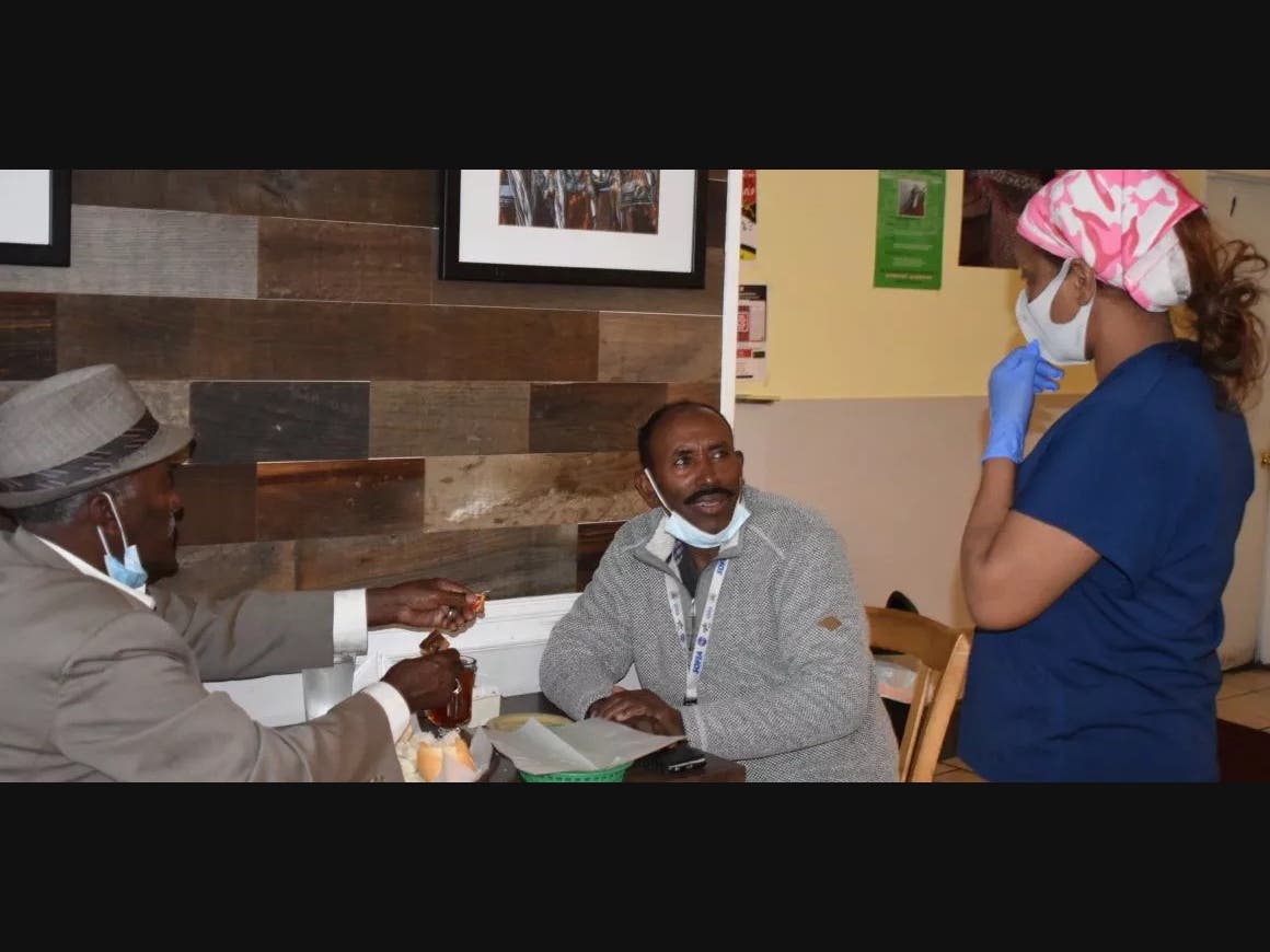 Zegay Siyoum (right) said he comes to Mudai as much for the company as the food. 