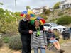 Cheryl and Dan LIndeman aren't afraid of a little rain with matching headwear as Ron Quirk looks on in the background.