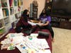 Abhinaya Mukundan and Dheeksha Sudhakar of SB Peer Pals sort through cards and posters. 