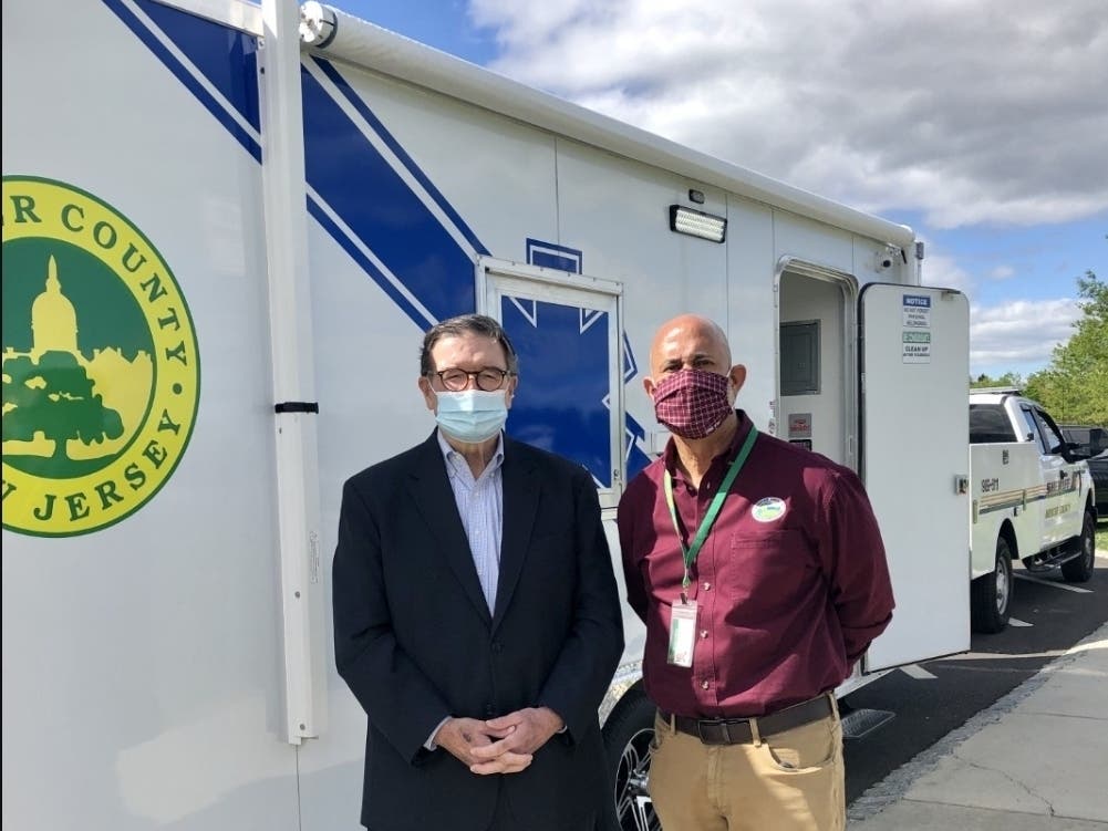 Mercer County Executive Brian M. Hughes and Mercer County Park Commission Executive Director Aaron T. Watson outside the new mobile vaccination unit. 
