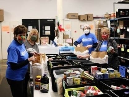 HomeFront volunteers packing grocery bags which provided over 735,750 meals last year to local families.