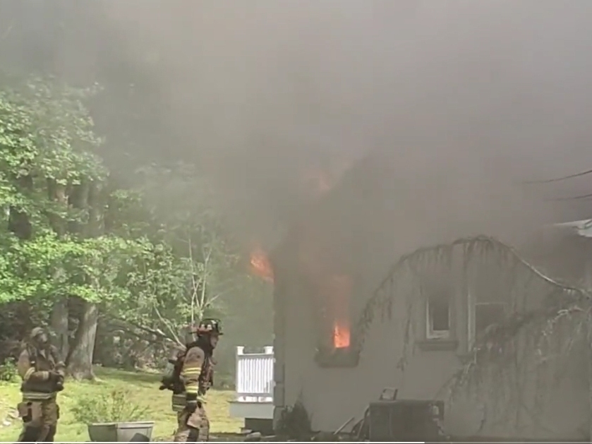 Firefighters battle the blaze at a Riva Avenue group home.  