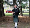 John O'Keefe playing "Amazing Grace" on bagpipes
