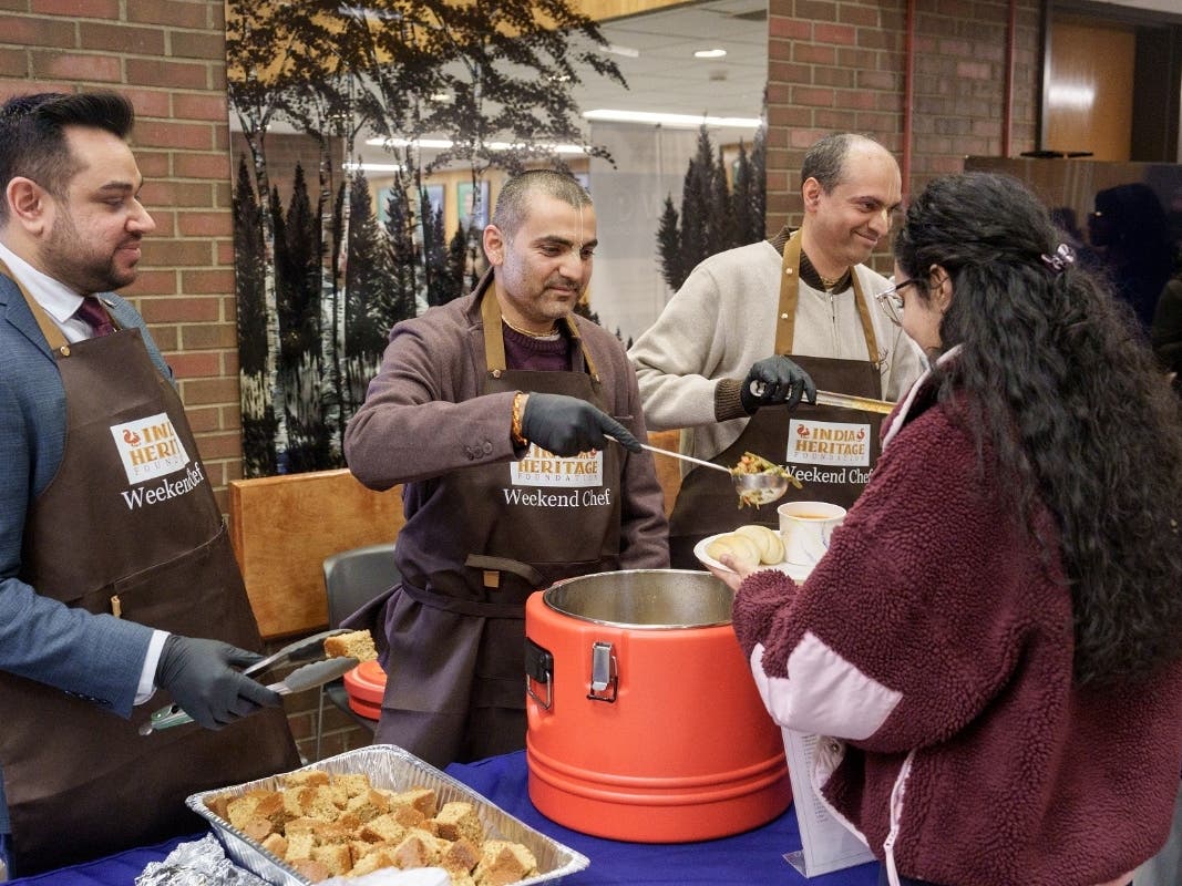 Mayor Sam Joshi (left) joins members of the World Food Movement in serving meals during the program's launch.