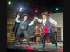 Actors Matt North and Sarah Kowalchuk enact a daring duel while Alex Maron looks on.
