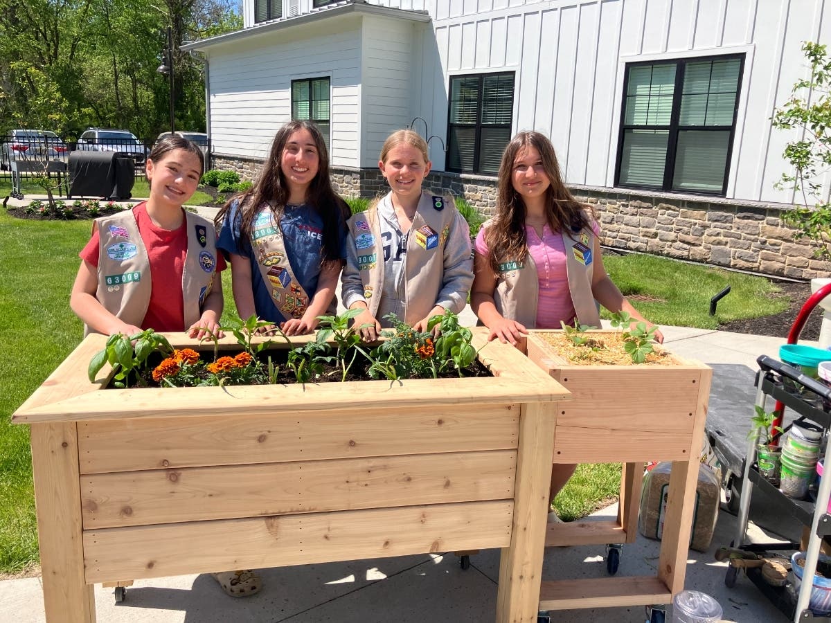 Girl Scouts pose with their project