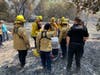 Firefighters and police officers work to get all 105 animals from the Lucky Ones Sanctuary to safety. 