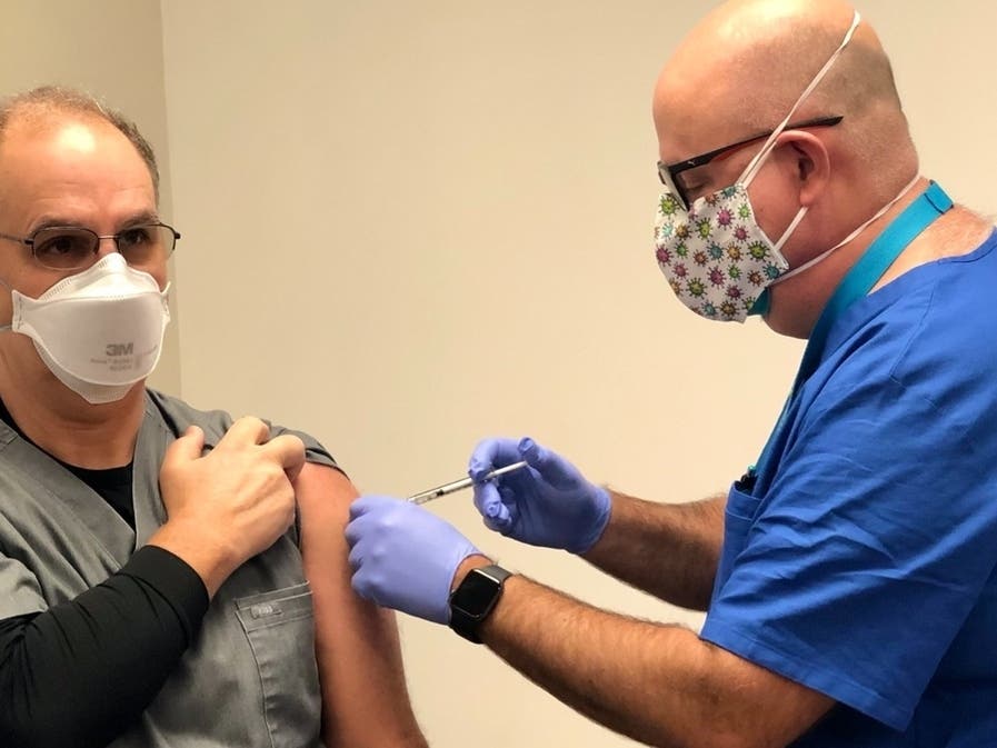 HEALDSBURG, CA — Chief of Surgery Dr. Joseph Tito administers the Pfizer coronavirus vaccine to Emergency Department Director Dr. Bruce Deas at Healdsburg Hospital.