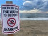 Signs posted in Huntington Beach warn beachgoers not to enter the water this week after a leaky pipeline unleashed 144,000 gallons of crude oil into the ocean. 