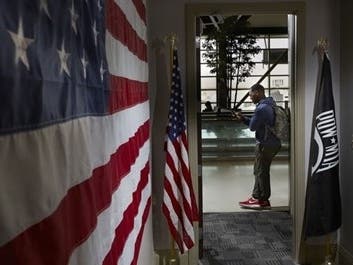 A military guest of the MI Freedom Center stands in the doorway of the military lounge at Detroit Metro Airport, provided free to active-duty service members and Veterans who are traveling.