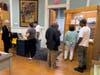 Enfield residents talk with Museum Docent while others review Strand Theater exhibit.